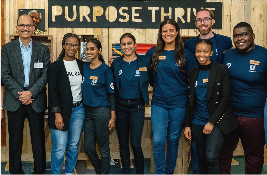 Eight Unilever team members at a Purpose Thrive event