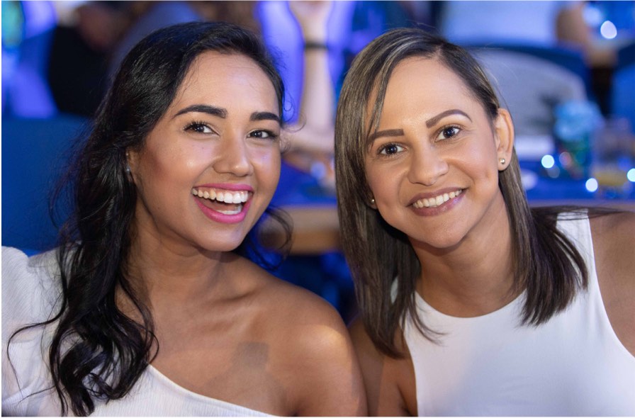 Two Unilever team members smiling at an event